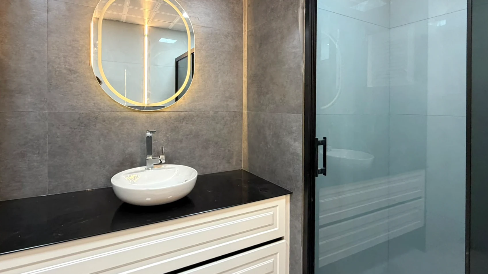 Countertop basin, illuminated mirror and separate shower enclosure